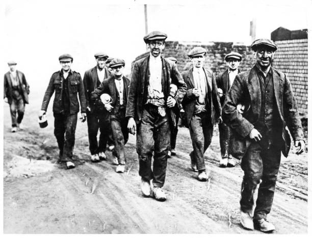 Miners walk home from a days work in England Circa 1940 Historic Old Photo-image